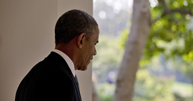 President Obama walks from his residence to the Oval Office at the White House