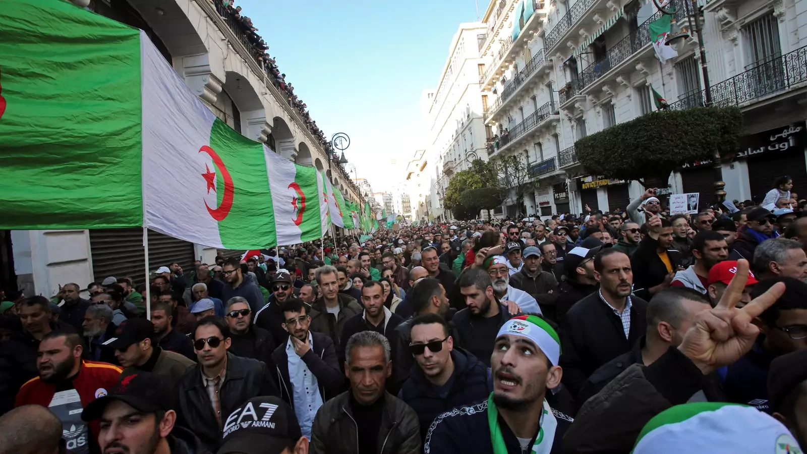 Demonstrators carry a national flag during an anti-government rally in Algiers, Algeria January 3, 2020.