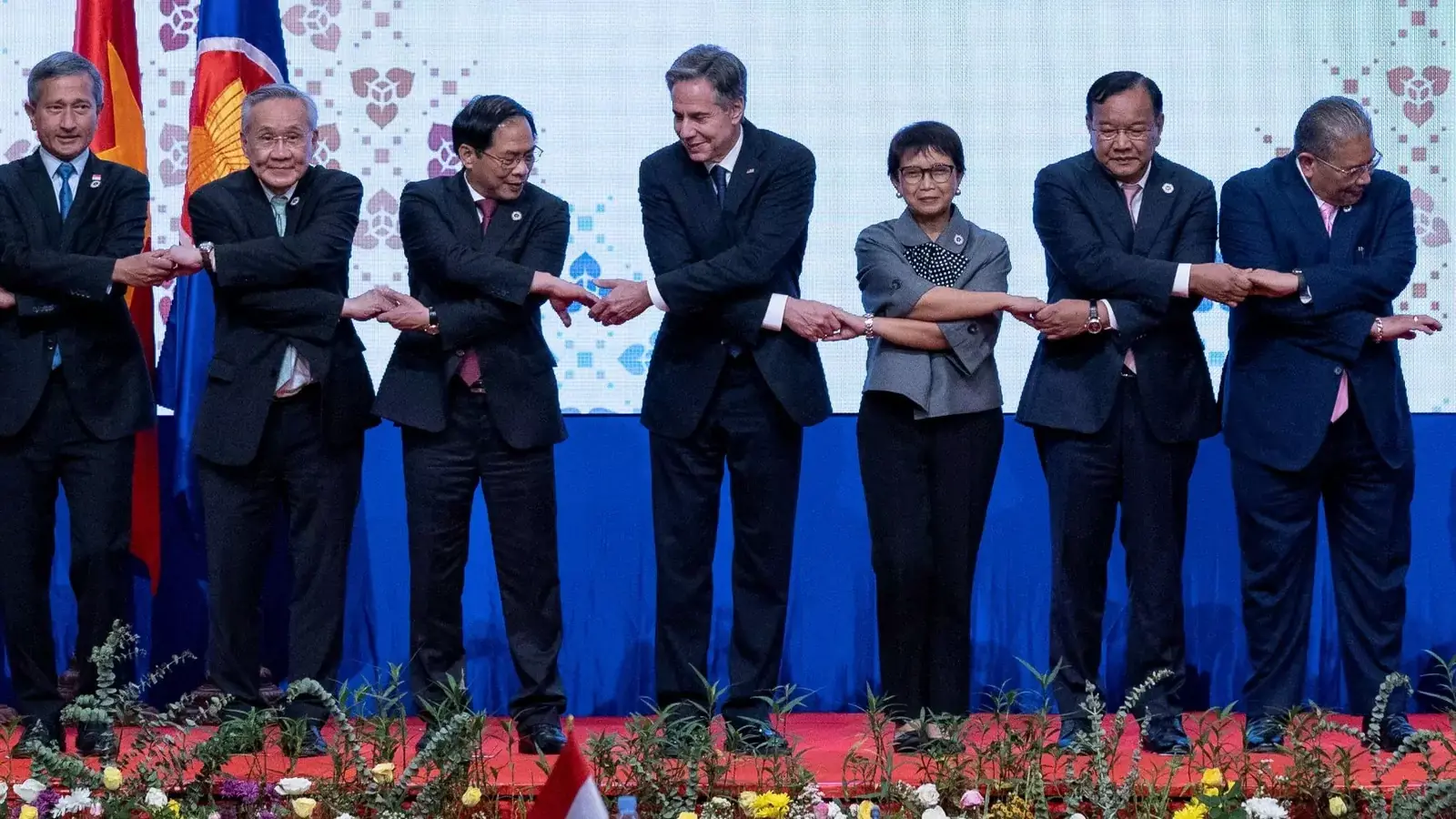 U.S. Secretary of State Antony Blinken and others do the "ASEAN-way handshake" for a group photo during the U.S.-ASEAN ministerial meeting in Phnom Penh, Cambodia on August 4, 2022.