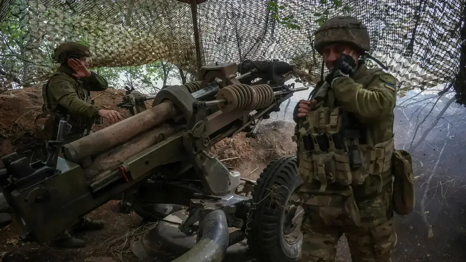 Ukrainian service members fire a L119 howitzer in Donetsk region.