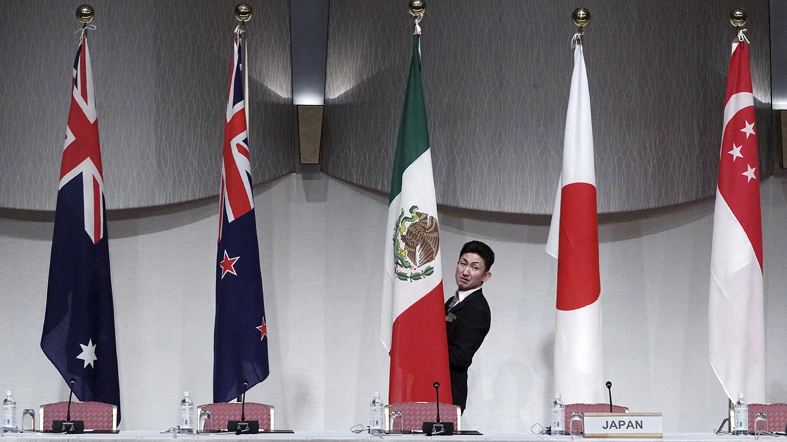 Flags are hung up in preparation for the Comprehensive and Progressive Trans-Pacific Partnership (CPTPP) joint press conference in Tokyo in 2019.