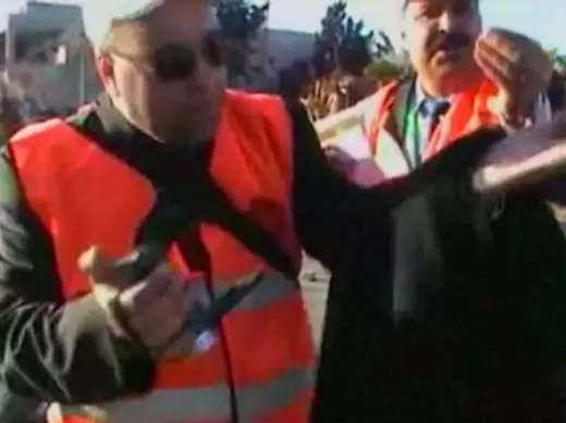 This still image taken from video uploaded to a social media website on December 28, 2011 shows Arab League monitors speak to the camera after seeing the body of a dead boy claimed to have been killed by Syrian security forces in what is purportedly Homs (Courtesy Reuters).