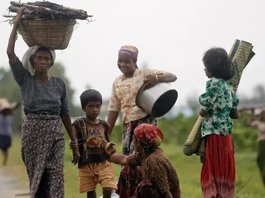 Rohingya Muslims carry their belongings as they move after recent violence in Sittwe June 16, 2012.