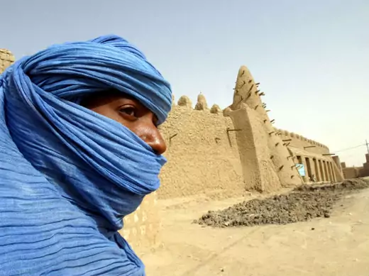 A Tuareg nomad stands near the 13th century mosque at Timbuktu, Mali, where U.S. Special Forces have been training the Malian army to better police the Sahara Desert, March 19, 2004.