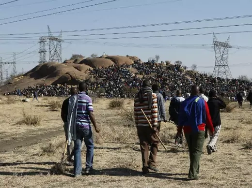 Striking miners arrive at a gathering outside a South African mine in Rustenburg, 100 km (62 miles) northwest of Johannesburg, August 14, 2012.