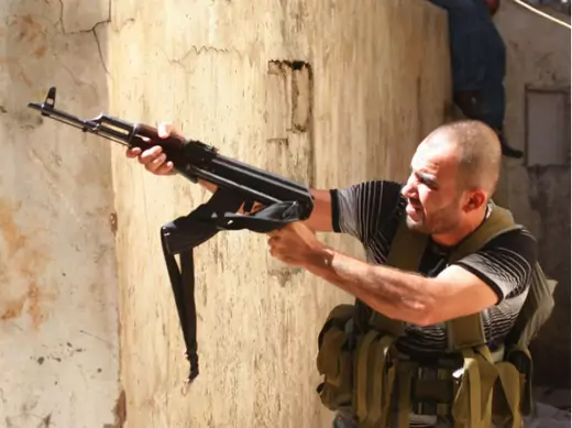 A Sunni Muslim gunman aims his rifle from the neighborhood of Bab al-Tebbaneh in Tripoli, northern Lebanon, during clashes between Sunni Muslims and Alawites on August 22, 2012 (Courtesy Reuters).