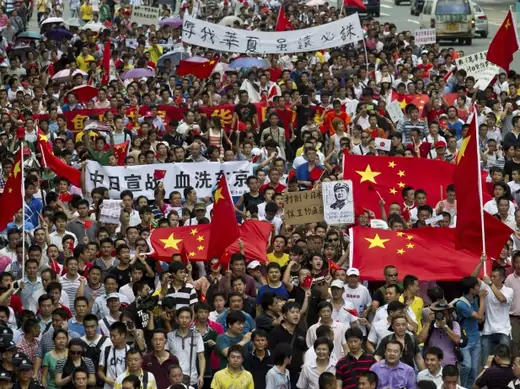 Protesters march down a street during an anti-Japan protest in Shenzhen on August 19, 2012.