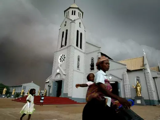 Storm clouds gather over the Church of the Holy Trinity in Onitsha, Nigeria, April 14, 2005.