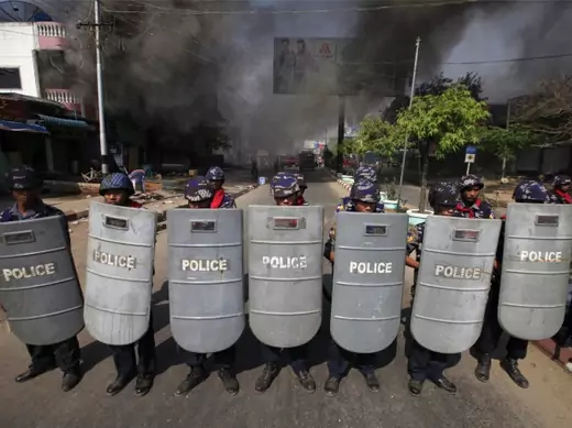 Riot policemen form up near a fire during riots in Meikhtila on March 22, 2013. 