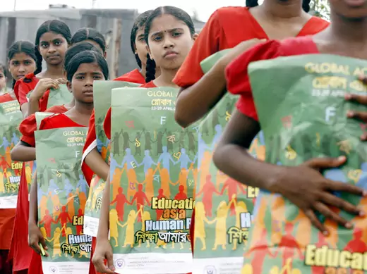 Primary school students march by the bank of the river Buriganga during an event in support of education in Dhaka