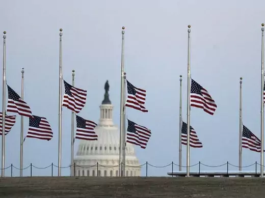 American flags fly at half mast. (Jonathan Ernst/Courtesy Reuters)