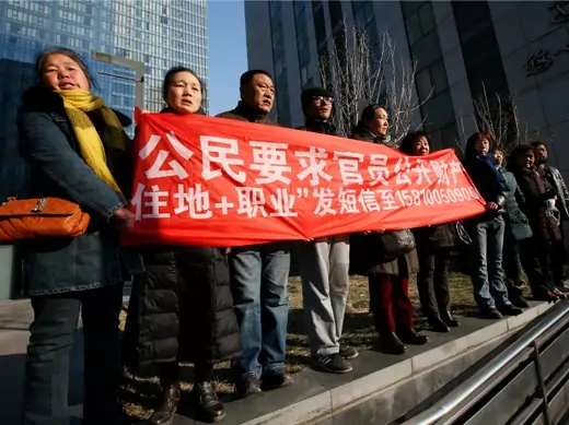 Supporters of Xu Zhiyong, one of China's most prominent rights advocates, shout slogans near a court where Xu's trial is being held, in Beijing on January 22, 2014. (Kim Kyung-hoon/Courtesy Reuters)