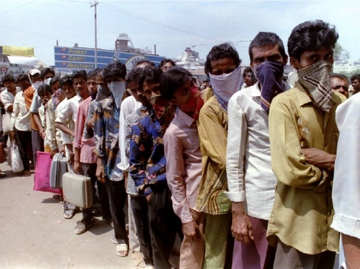 Masked residents of Surat queue up for train tickets for the first train out of the city on September 25 as the death toll due to pneumonic plague continues to climb. Government officials are concerned about the spread of the disease to other cities due to the exodus of people from Surat