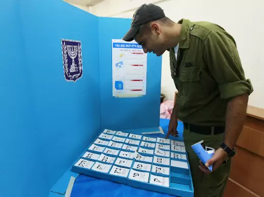 An Israeli soldier picks his ballot at a polling station in a navy base in the southern city of Ashdod January 20, 2013 (Cohen/Courtesy Reuters).