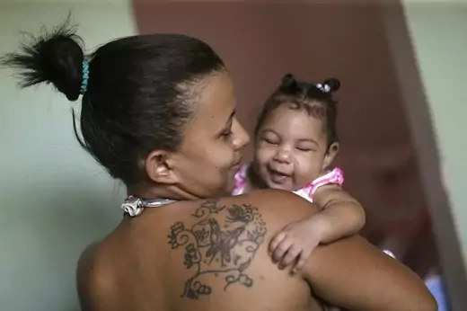 Rosana Vieira Alves holds her 4-month-old daughter Luana Vieira, who was born with microcephaly, pictured here at their house on February 3, 2016 in Brazil, which is investigating more than 4,000 suspected cases of this birth disorder, which may be linked to the Zika outbreak. REUTERS/Ueslei Marcelino