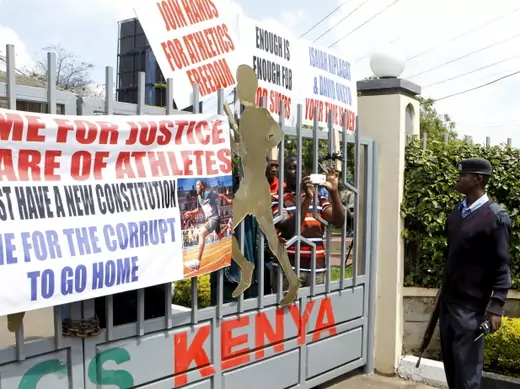 A policeman is seen outside the gates of Riadha House the Athletic Kenya (AK) Headquarters during a protest in capital Nairobi November 23, 2015. Dozens of Kenyan athletes stormed the athletics federation headquarters in Nairobi on Monday, locking out officials and demanding that top Athletics Kenya (AK) bosses step down following allegations of graft and doping cover-ups (Reuters/Noor Khamis).