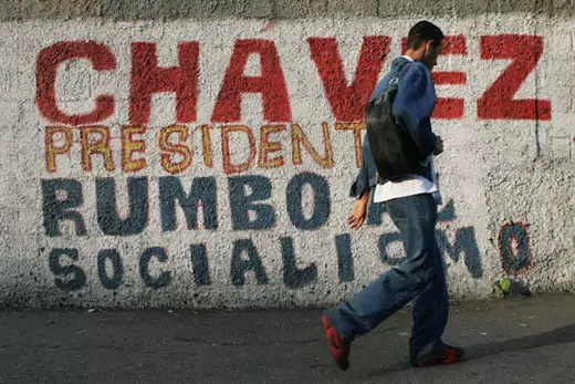 The mural reads "Chávez, President, on the way to socialism."  AP Images/Leslie Mazoch