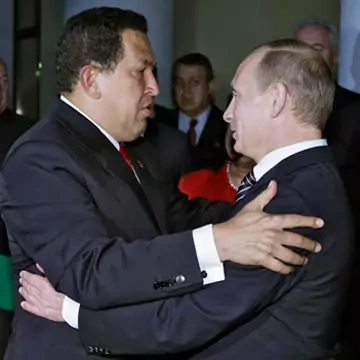 Then-Russian Prime Minister Vladimir Putin and Chávez embrace after September 2009 talks. RIA Novosti/Alexei Druzhinin/Reuters