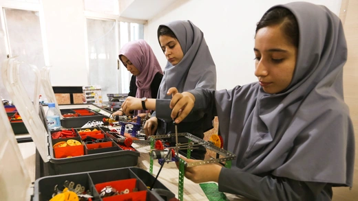 Members of Afghan robotics girls team work on their robots in Herat province.