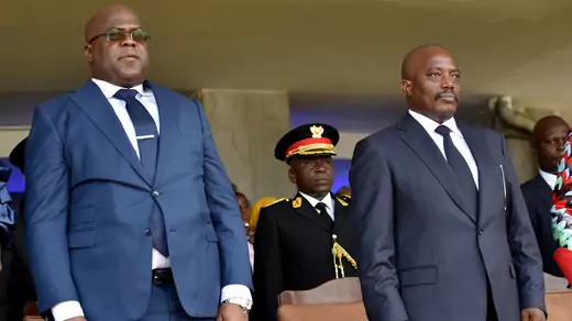 DRC outgoing President Kabila and his successor Felix Tshisekedi stand during Tshisekedi's inauguration ceremony