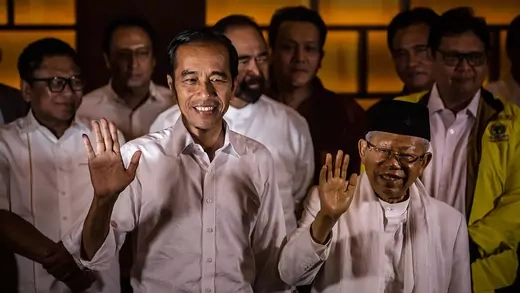 President Joko Widodo and his vice presidential candidate Maruf Amin wave during a press conference after Indonesia's election.