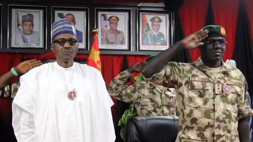 Nigerian president Muhammadu Buhari stands next to Chief of Army Staff Tukur Yusuf Buratai during the opening ceremony of the military staff annual conference, on November 28, 2018, during his trip to visit troops fighting Boko Haram.