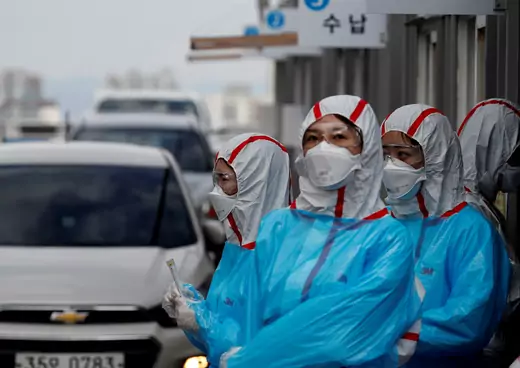 Medical staff in protective gear work at a 'drive-thru' testing center for the novel coronavirus disease of COVID-19 in Yeungnam University Medical Center in Daegu, South Korea.
