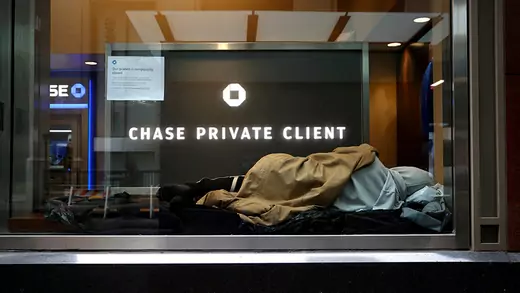 A man sleeps in a closed bank