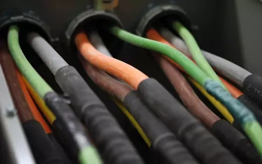 Fiber optic cables carrying internet providers are seen running into a server room.