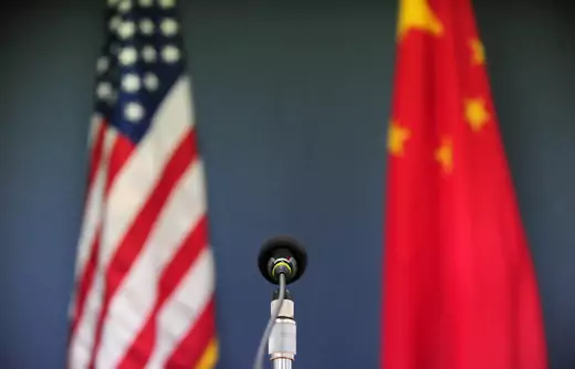 The U.S. and Chinese flags at a press conference at the U.S. Embassy in Beijing.