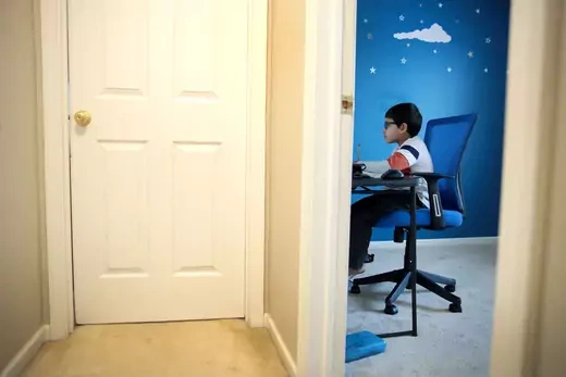 Seven-year-old Hamza Haqqani, a 2nd grade student at Al-Huda Academy, uses a computer to participate in an E-learning class with his teacher and classmates while at his home on May 01, 2020 in Bartlett, Illinois. Al-Huda Academy, an Islam based private school that teaches pre-school through the 6th grade students, has had to adopt an E-learning program to finish the school year after all schools in the state were forced to cancel classes in an attempt to curtail the spread of the COVID-19 pandemic.