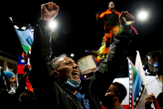 Supporters of the "I Approve" option react after hearing the results of the referendum on a new Chilean constitution 