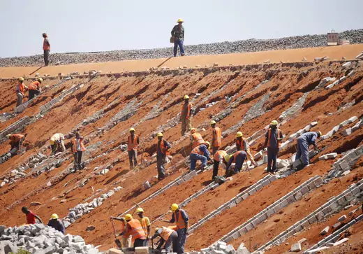 Construction workers law concrete blocks for drainage near the new standard gauge railway line near Voi town, Kenya on March 16, 2016.