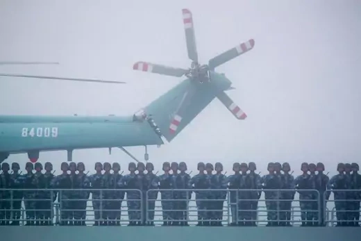 Soldiers stand on deck of the ambitious transport dock Yimen Shan of the Chinese People's Liberation Army (PLA) Navy as it participates in a naval parade to commemorate the 70th anniversary of the founding of China's PLA Navy in the sea near Qingdao in eastern China's Shandong province, on April 23, 2019.