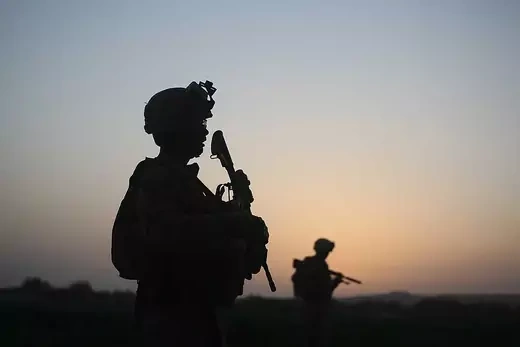 U.S. Marines with the 2nd Marine Expeditionary Brigade, RCT 2nd Battalion 8th Marines Echo Co. step off in the early morning during an operation to push out Taliban fighters on July 18, 2009 in Herati, Afghanistan.