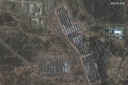 An aerial image shows armored personnel carriers parked by Russian troops near the Russia-Ukraine border.