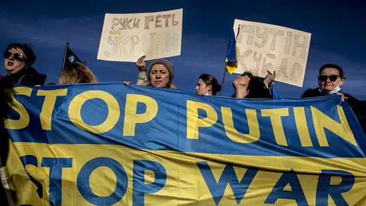 Protesters from the Christian Ukrainian Community of Rome hold signs, including one that reads, "Stop Putin, stop war."