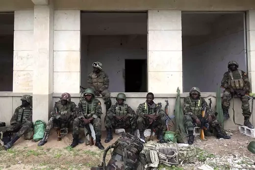 Ugandan peacekeepers from African Union Mission in Somalia (AMISOM) sit outside the stadium in southern Mogadishu 