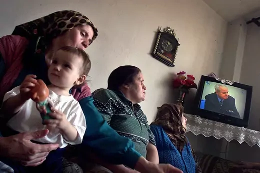Muslim refugee women, survivors from once U.N. safe zone of Srebrenica, watch live TV coverage of trial of former Yugoslav President Slobodan Milosevic.