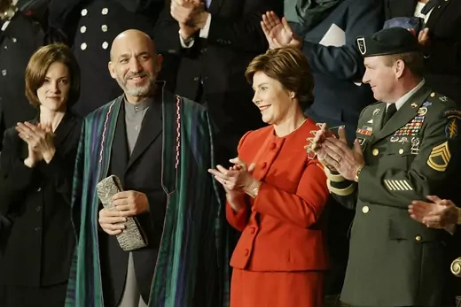 Afghan leader Hamid Karzai attends the 2002 State of the Union address alongside U.S. First Lady Laura Bush.
