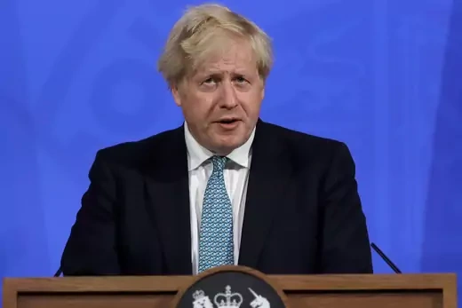 Prime Minister Boris Johnson stands at a lectern.