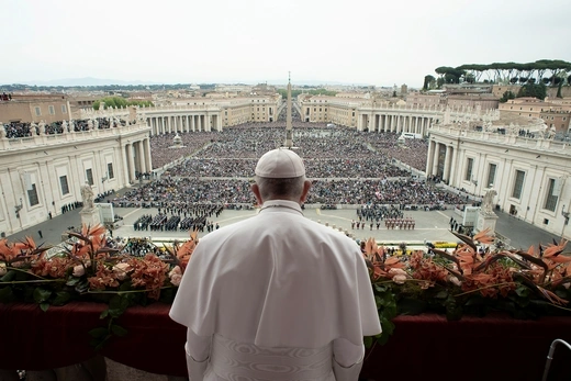 The pope looks out at a large crowd at Vatican City