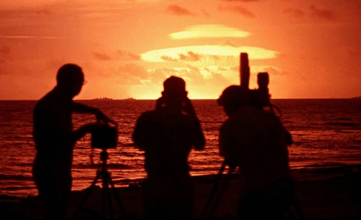 Photo showing Photographers and camera crew filming nuclear tests conducted by the United States in 1958. 