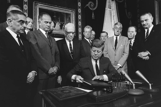 Photo showing President John F. Kennedy signing the Limited Test Ban Treaty with the Soviet Union in 1963. 