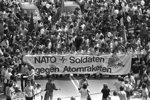 Photo showing German soldiers and protesters holding a banner reading "NATO soldiers against nuclear missiles" in a massive demonstration attended by about 150,000 people against NATO summit which opened in Bonn. 
