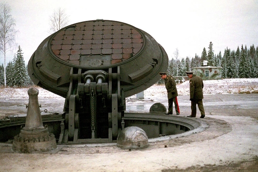 Photo showing two Russian military officials peering into an opened silo of an intercontinental ballistic Topol-M missile at an undisclosed location.