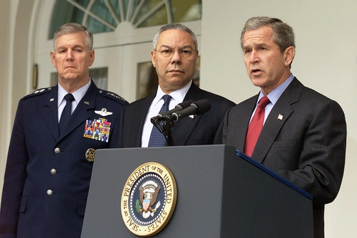 Photo showing President George W. Bush announcing the United States withdrawal from the ABM Treaty as Secretary of State Colin Powell looks on.