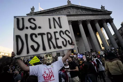 An Occupy Wall Street protester holds a sign reading "U.S. In Distress"