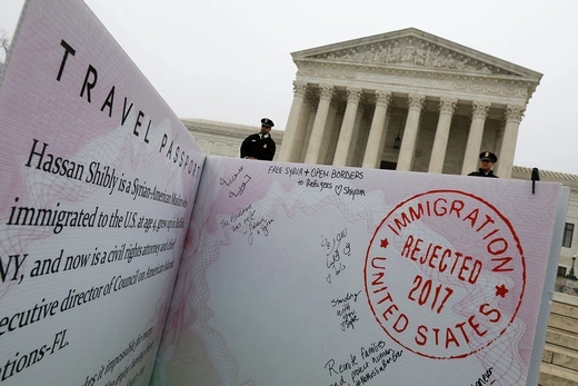 A mock-up of a Muslim traveler’s passport is placed outside the U.S. Supreme Court.