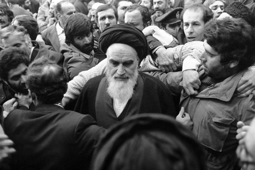Ayatollah Khomeini is thronged by his supporters after delivering his speech at the airport in Tehran.